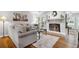 Cozy living room with a fireplace, hardwood floors, and a neutral color palette at 3408 Lake Pointe Cir, Roswell, GA 30075