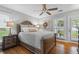 Comfortable main bedroom with hardwood floors, ceiling fan, and access to outdoor balcony at 3408 Lake Pointe Cir, Roswell, GA 30075