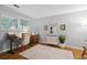 Bright office with hardwood floors, a modern desk, and natural light from large windows at 3408 Lake Pointe Cir, Roswell, GA 30075