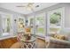 Inviting sunroom with a ceiling fan and plantation shutters at 3408 Lake Pointe Cir, Roswell, GA 30075