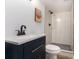 Modern bathroom featuring a walk-in shower with black fixtures and a blue vanity with a quartz countertop at 3181 Pennington Sw Cir, Atlanta, GA 30354