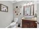 Charming powder room with a vessel sink and decorative accents at 1005 Wellers Ct, Roswell, GA 30076
