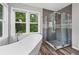 Spa-like bathroom with a freestanding tub and a glass-enclosed shower at 1005 Wellers Ct, Roswell, GA 30076