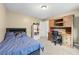 Bedroom with bed, desk, wood bookshelf and white shelf at 1005 Wellers Ct, Roswell, GA 30076
