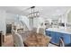 Dining room with modern lighting and view to the kitchen, creating an open space at 1005 Wellers Ct, Roswell, GA 30076