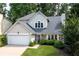 Charming home with stone accents, well-maintained lawn, and attached two-car garage at 1005 Wellers Ct, Roswell, GA 30076
