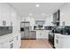 Bright kitchen featuring stainless steel appliances, white cabinets, and quartz countertops at 1005 Wellers Ct, Roswell, GA 30076