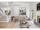 Bright living area with fireplace, wooden accents and access to a second-story landing at 1005 Wellers Ct, Roswell, GA 30076