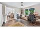 Cozy office space with large windows, built-in shelving, and wood flooring at 1005 Wellers Ct, Roswell, GA 30076
