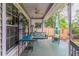 Cozy back porch features ceiling fan, green rocking chairs, and a swing at 1115 Hunters Creek Ct, Lawrenceville, GA 30043