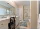 Bright bathroom featuring a vanity, soaking tub, and neutral tile flooring at 1115 Hunters Creek Ct, Lawrenceville, GA 30043