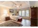 Bedroom with vaulted ceilings, natural light from large windows, and hardwood floors at 1115 Hunters Creek Ct, Lawrenceville, GA 30043