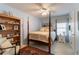 Bedroom featuring four-poster bed and shelving at 1115 Hunters Creek Ct, Lawrenceville, GA 30043
