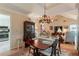 Elegant dining room with a wooden table, ornate chandelier, and hardwood floors flowing into the living area at 1115 Hunters Creek Ct, Lawrenceville, GA 30043