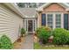 Close-up of front door with landscaped entry and brick detailing at 1115 Hunters Creek Ct, Lawrenceville, GA 30043