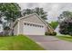 Attached garage with a long driveway and well-manicured lawn at 1115 Hunters Creek Ct, Lawrenceville, GA 30043