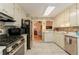 Bright kitchen with white cabinetry, marble countertops, stainless steel appliances and mosaic tile backsplash at 1115 Hunters Creek Ct, Lawrenceville, GA 30043