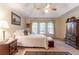 Spacious main bedroom with vaulted ceiling, large windows, and a dark wood armoire at 1115 Hunters Creek Ct, Lawrenceville, GA 30043