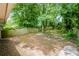A spacious backyard with a wood fence, mature trees, and a patio, perfect for outdoor activities at 1381 Benteen Way Southeast, Atlanta, GA 30315