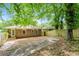 Backyard featuring wooden fence, trees, and a glimpse of the home's brick exterior, offering a private outdoor space at 1381 Benteen Way Southeast, Atlanta, GA 30315