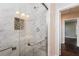 Bathroom featuring glass shower doors, marble tile, and modern fixtures at 1381 Benteen Way Southeast, Atlanta, GA 30315