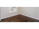 This bedroom features refinished hardwood floors, neutral paint and a window at 1381 Benteen Way Southeast, Atlanta, GA 30315