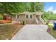 Charming single-story home with a brick facade, concrete driveway, and landscaped front yard at 1381 Benteen Way Southeast, Atlanta, GA 30315