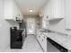 Galley kitchen with white cabinets, stainless appliances, granite countertops, and ample counter space at 1381 Benteen Way Southeast, Atlanta, GA 30315