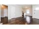 Open-concept living room featuring hardwood floors and access to the kitchen and multiple rooms at 1381 Benteen Way Southeast, Atlanta, GA 30315