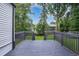 Back deck with dark paint overlooking backyard with greenery at 1398 Woodland Ave, Atlanta, GA 30316