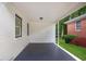 Covered back porch with painted concrete floor and white vinyl siding at 1398 Woodland Ave, Atlanta, GA 30316