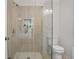 Bathroom featuring an updated glass-enclosed shower with gray tiles and a modern toilet at 1398 Woodland Ave, Atlanta, GA 30316