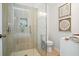 Bathroom featuring a glass shower enclosure, neutral tiling, a toilet, and white vanity at 1398 Woodland Ave, Atlanta, GA 30316