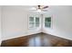 Bright bedroom with hardwood flooring and two windows for natural light at 1398 Woodland Ave, Atlanta, GA 30316