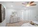 Bedroom with neutral carpet and wall colors featuring a light-colored dresser and art on the wall at 1398 Woodland Ave, Atlanta, GA 30316