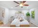 Bright bedroom with a ceiling fan, natural light, carpeted floor, and a light-colored wooden bed at 1398 Woodland Ave, Atlanta, GA 30316