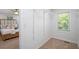 Walk-in closet attached to bedroom features shelving, a window, and carpeted floor at 1398 Woodland Ave, Atlanta, GA 30316