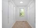 Walk-in closet with adjustable shelving and neutral carpeting at 1398 Woodland Ave, Atlanta, GA 30316