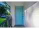 Close up of the light blue, paneled front door with a black handle and sidelight at 1398 Woodland Ave, Atlanta, GA 30316