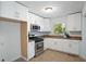 Kitchen with white cabinets, stainless steel appliances, and great natural light at 1398 Woodland Ave, Atlanta, GA 30316