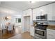 Well-lit kitchen featuring stainless steel appliances and views to the dining area at 1398 Woodland Ave, Atlanta, GA 30316