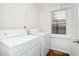 Laundry room featuring a washer and dryer with a window providing natural light at 1398 Woodland Ave, Atlanta, GA 30316