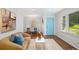 Cozy living room with views to the dining area and charming blue front door at 1398 Woodland Ave, Atlanta, GA 30316