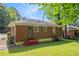 This backyard features a well-maintained lawn and a charming, classic brick house exterior at 2329 Polar Rock Sw Ave, Atlanta, GA 30315