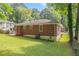 The backyard view features lush green lawn and a classic brick house exterior under a blue sky at 2329 Polar Rock Sw Ave, Atlanta, GA 30315