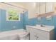 Bathroom featuring a tub, shower, toilet and sink with a window at 2329 Polar Rock Sw Ave, Atlanta, GA 30315