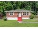 Charming red brick home with bright red stairs and a well-maintained lawn in a tree-lined neighborhood at 2329 Polar Rock Sw Ave, Atlanta, GA 30315