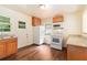 Charming kitchen with wood flooring, white appliances and ample counter space near a window at 2329 Polar Rock Sw Ave, Atlanta, GA 30315