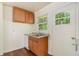 Practical kitchen area featuring stainless steel sink, wood cabinets and window at 2329 Polar Rock Sw Ave, Atlanta, GA 30315