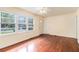Sun-filled living area with polished hardwood floors, a ceiling fan, and multiple windows for plenty of light at 2329 Polar Rock Sw Ave, Atlanta, GA 30315